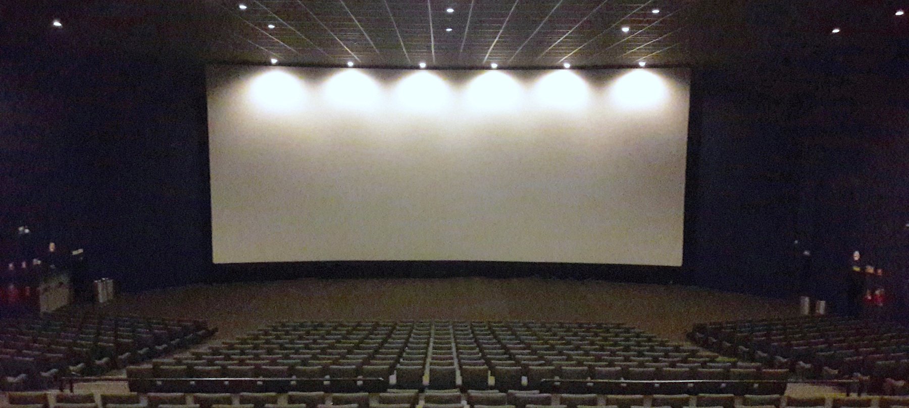Empty cinema auditorium with screen and seating