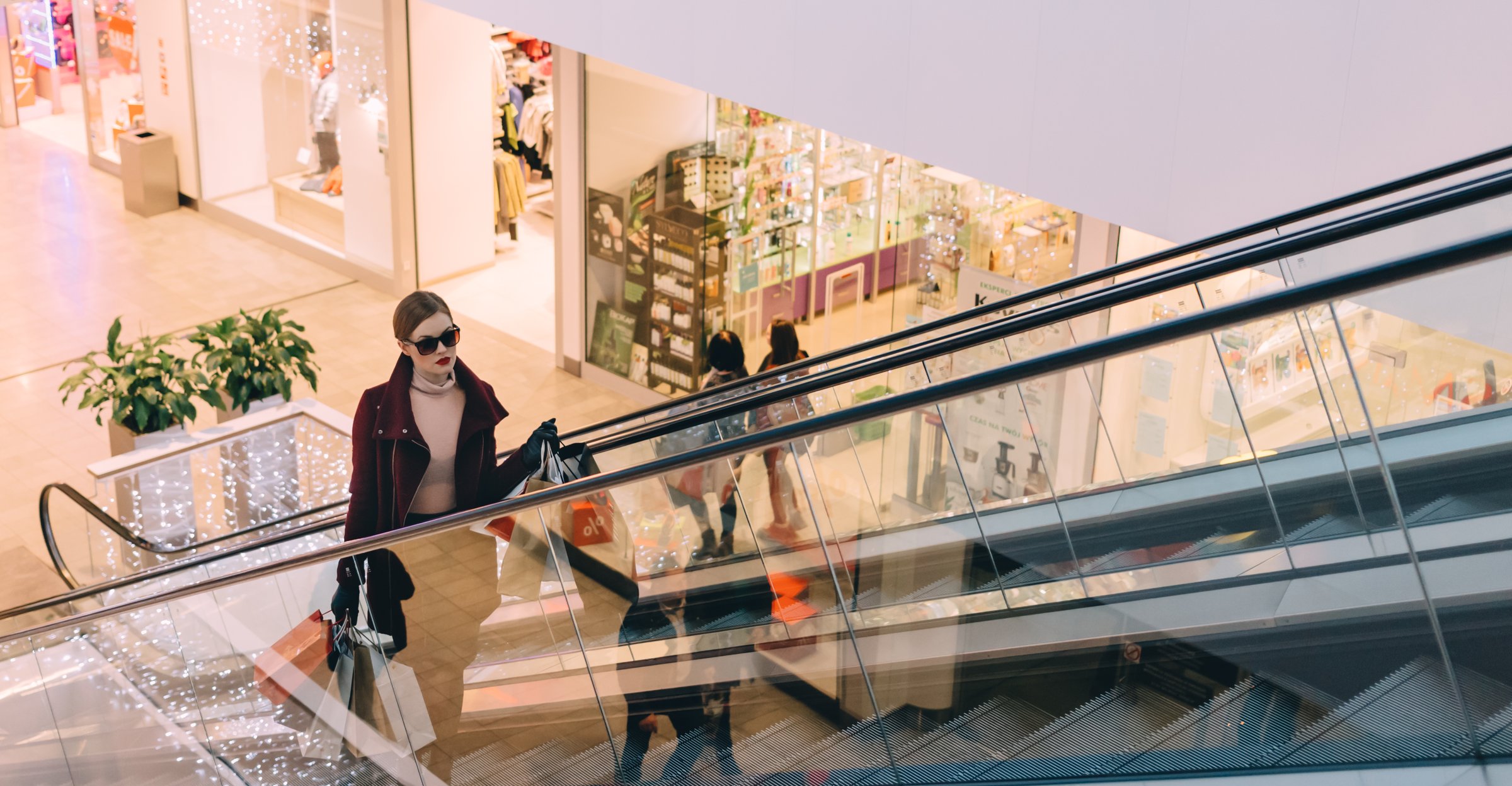Shopper on an escalator in a retail mall